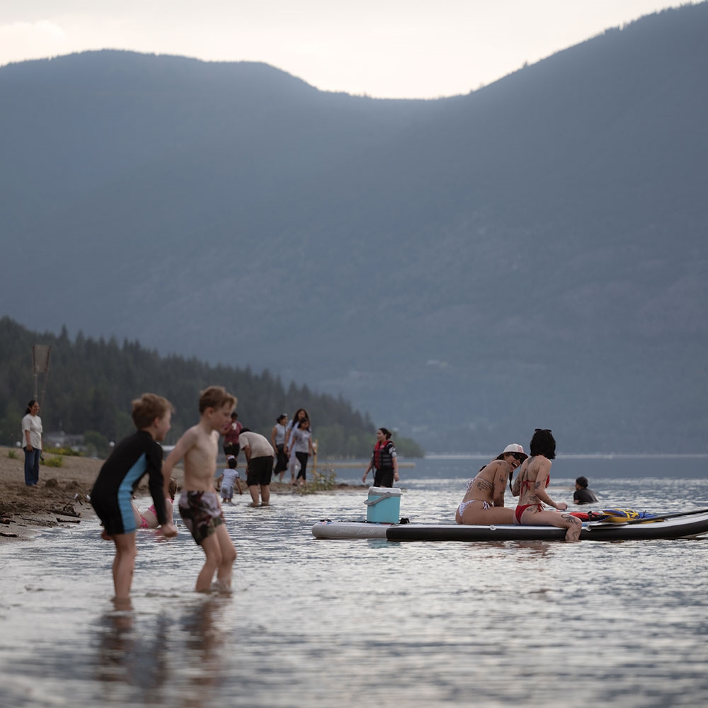 Kids playing in the sand and shallows at Canoe Beach